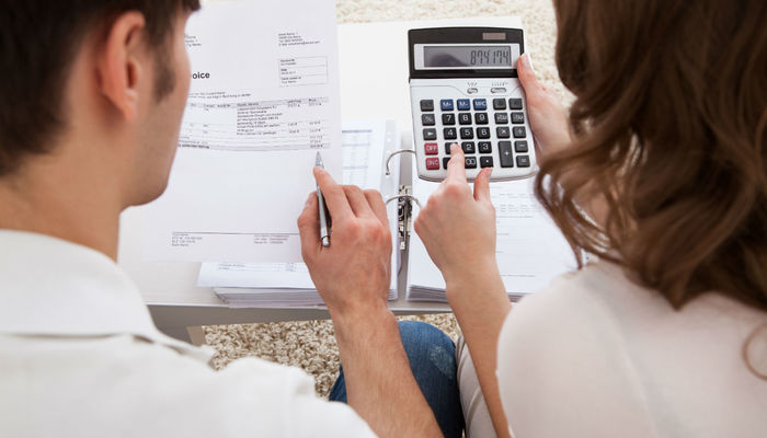 Two business owners calculating their budget