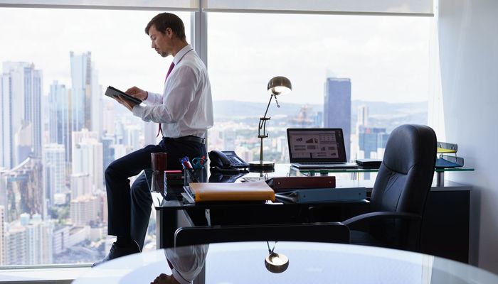 Businessman stood in office writing a press release