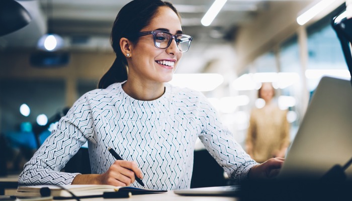 Happy employee working at her desk