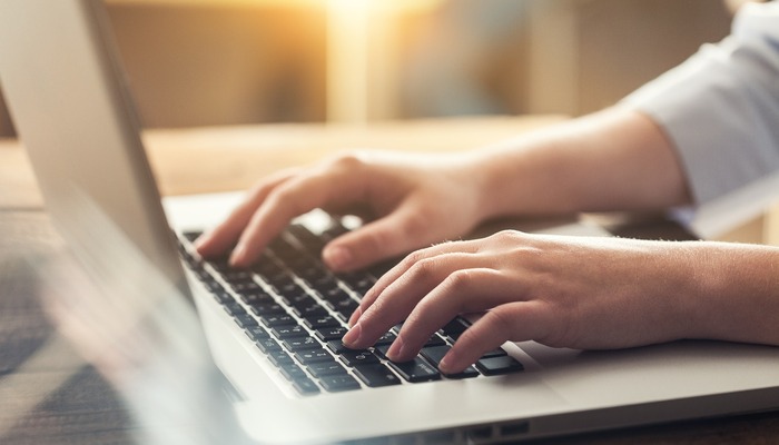 Woman typing on laptop