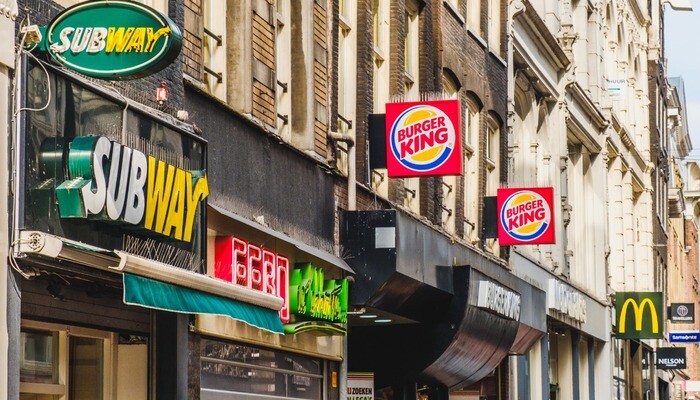Fastfood chain brand logos of Subway, Mcdonald and Burger King in City center of Amsterdam