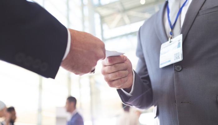 Two businesspeople swapping business cards