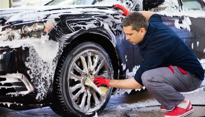 Man cleaning a car at a car wash