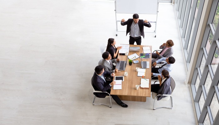 Small team conducting a business meeting in minimalist room