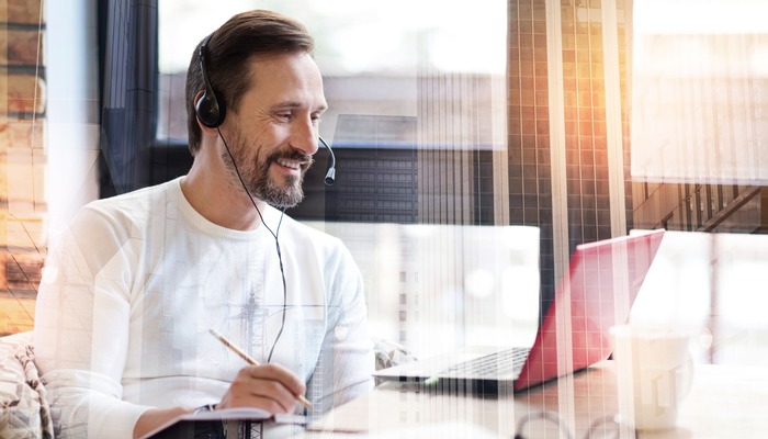 Remote worker at his desk with headset on