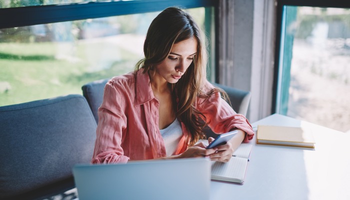 Woman in a cafe reading an email