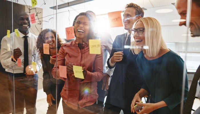 Laughing businesspeople having a brainstorming session in an off