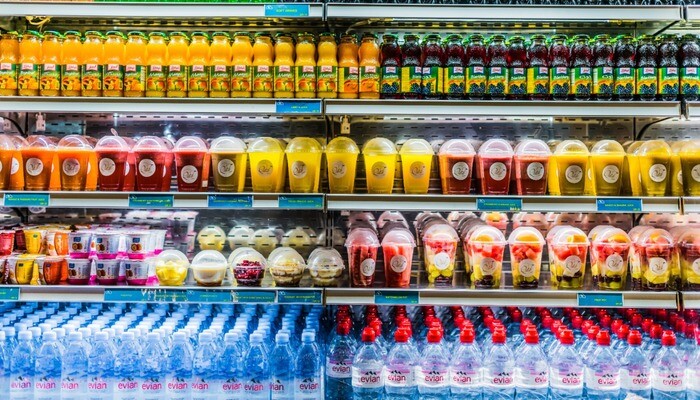 Cooled drinks and fruits displayed in a commercial refrigerator